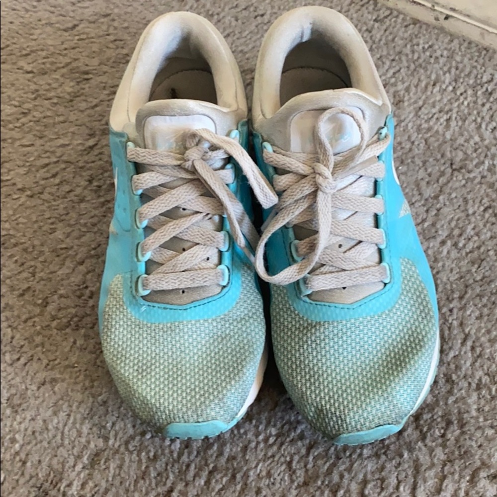 A blue and cream color Nike shoe